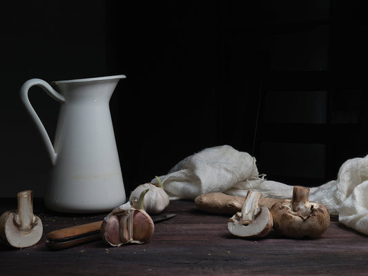 jug, knife and mushrooms on a dark wooden table
